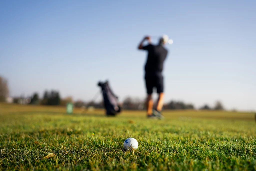 Golfball im Vordergrund, Felix Proske beim Abschlag – Triple Nine Open Golfturnier 2025